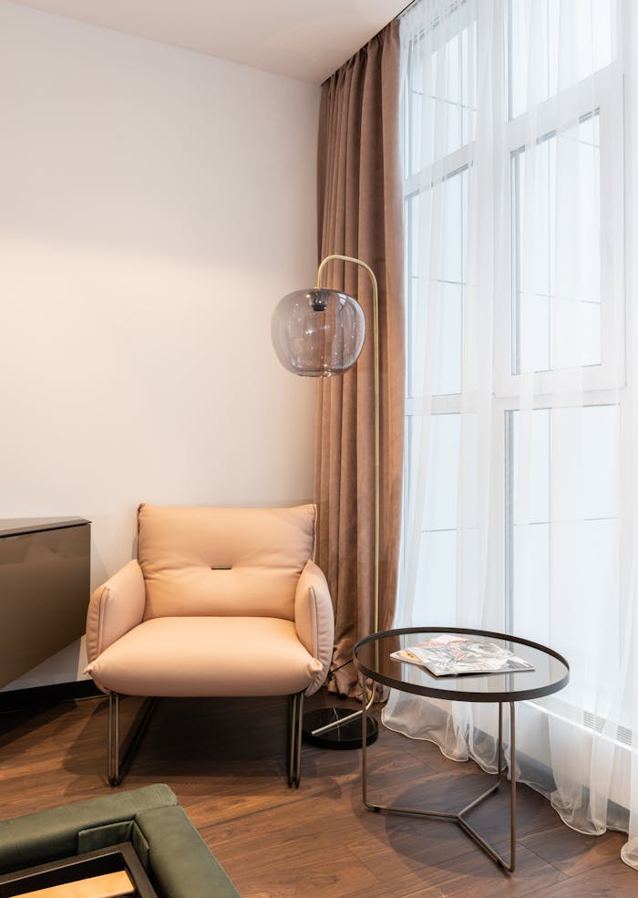 Cozy armchair and side table in a stylishly designed living room. Perfect for relaxation.